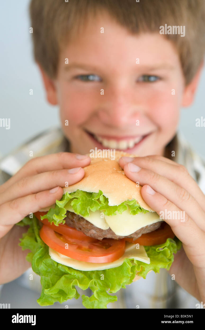 Child eating cheeseburger hires stock photography and images Alamy