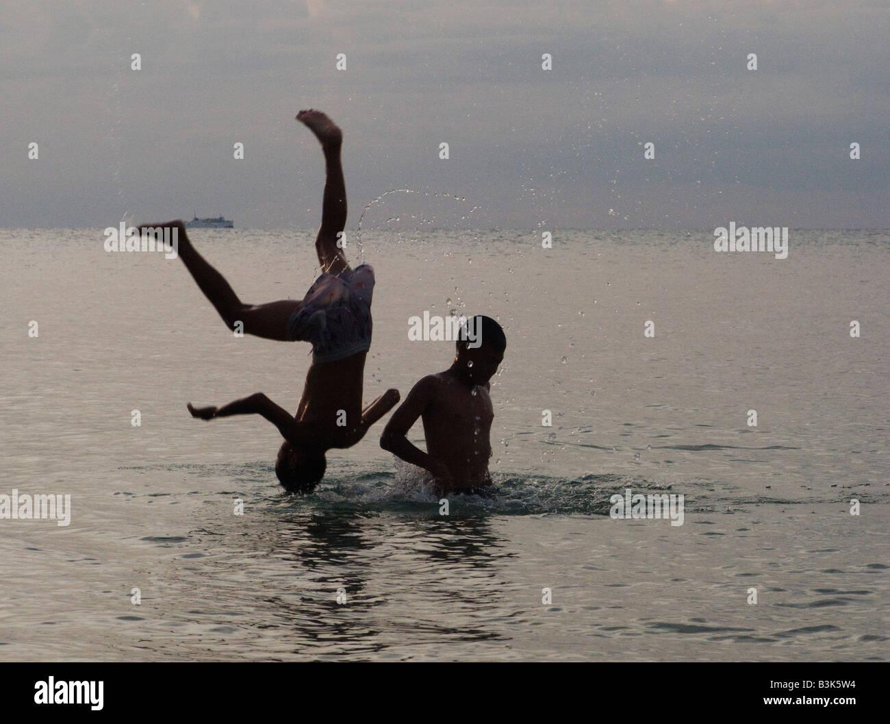 two boys playing in the sea Stock Photo - Alamy
