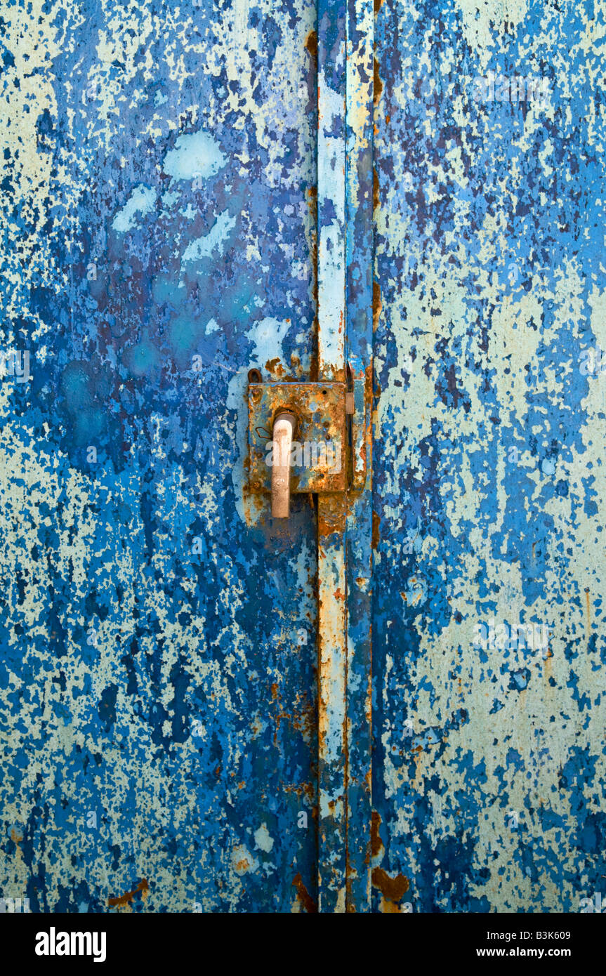 old metal door with peeling blue paint and rusty lock and handle Stock ...