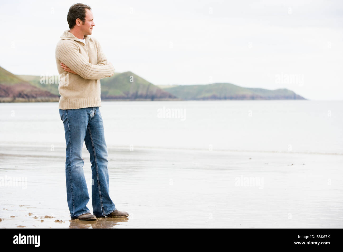 Thoughtful man walking on beach hi-res stock photography and images - Alamy
