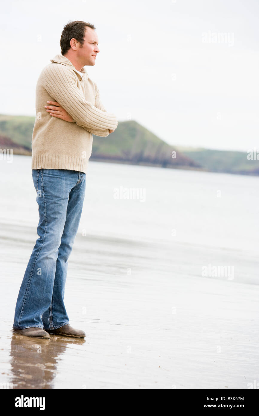 Thoughtful man walking on beach hi-res stock photography and images - Alamy