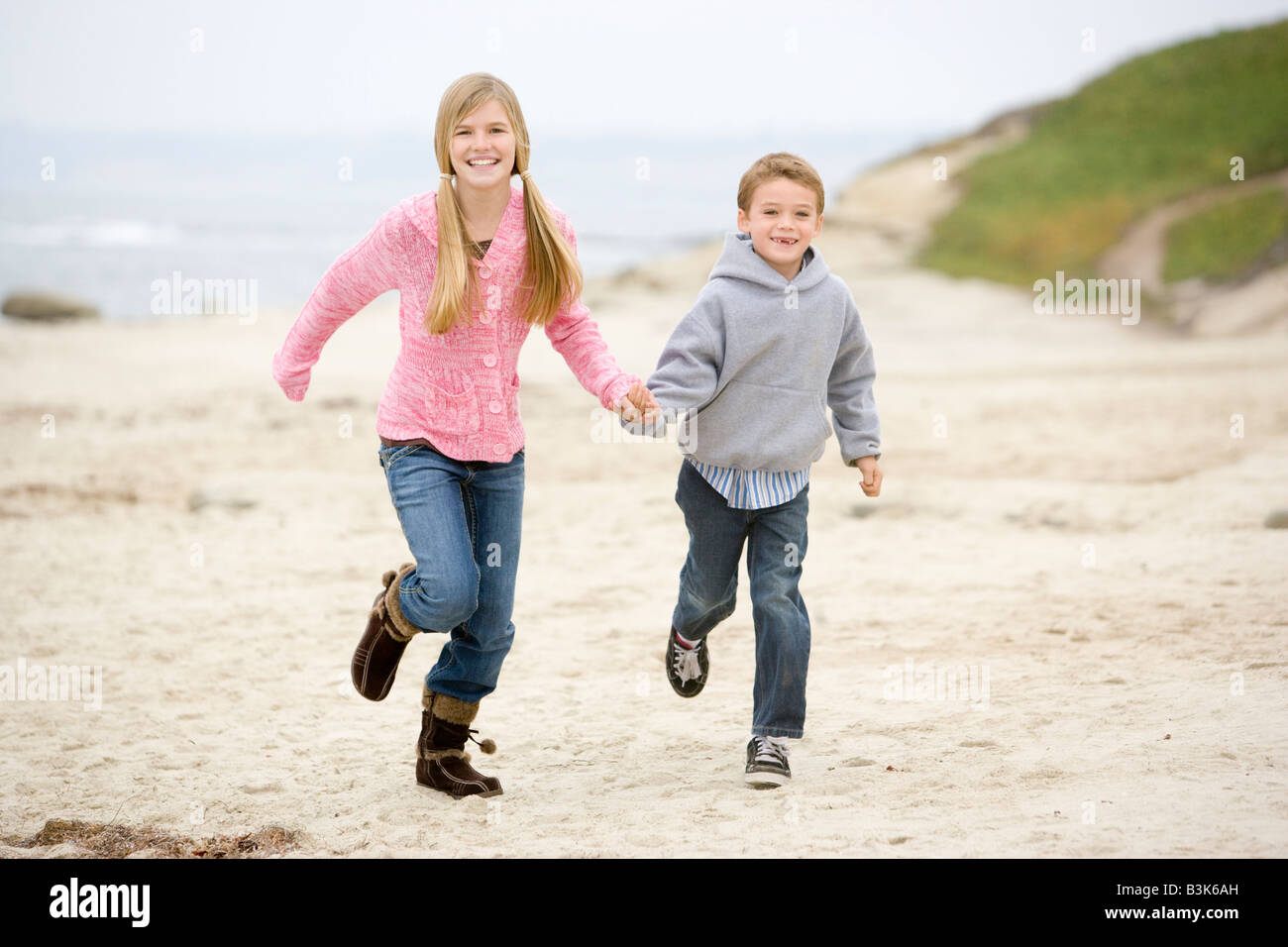 Brother And Sister Having Fun On Beach High Resolution Stock ...