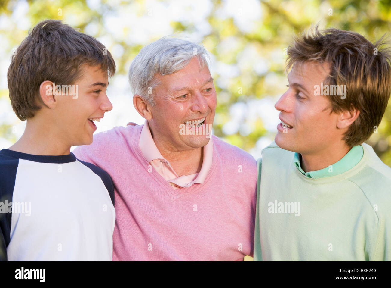 Grandfather with son and grandson smiling. Stock Photo
