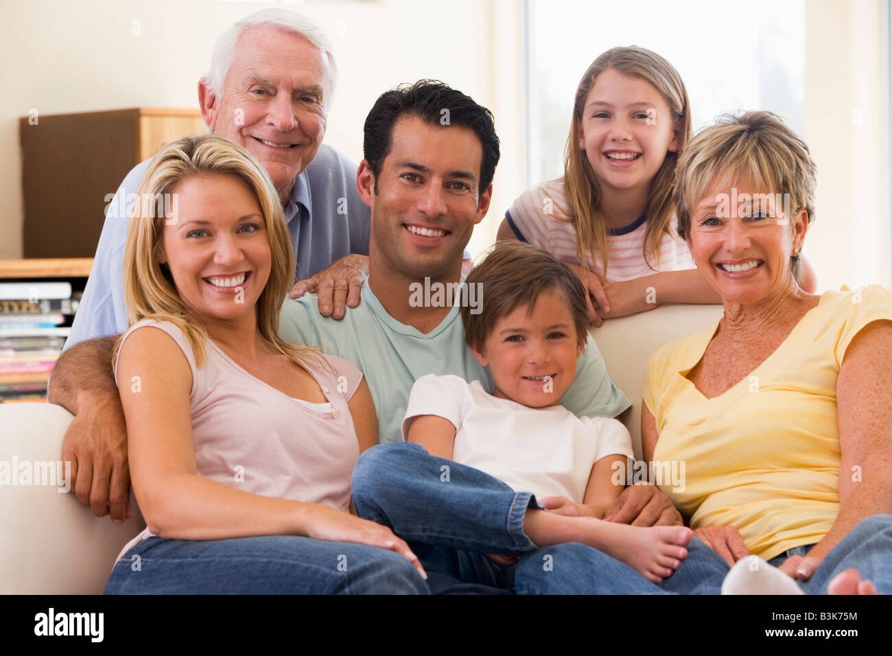 Extended family in living room smiling Stock Photo Alamy