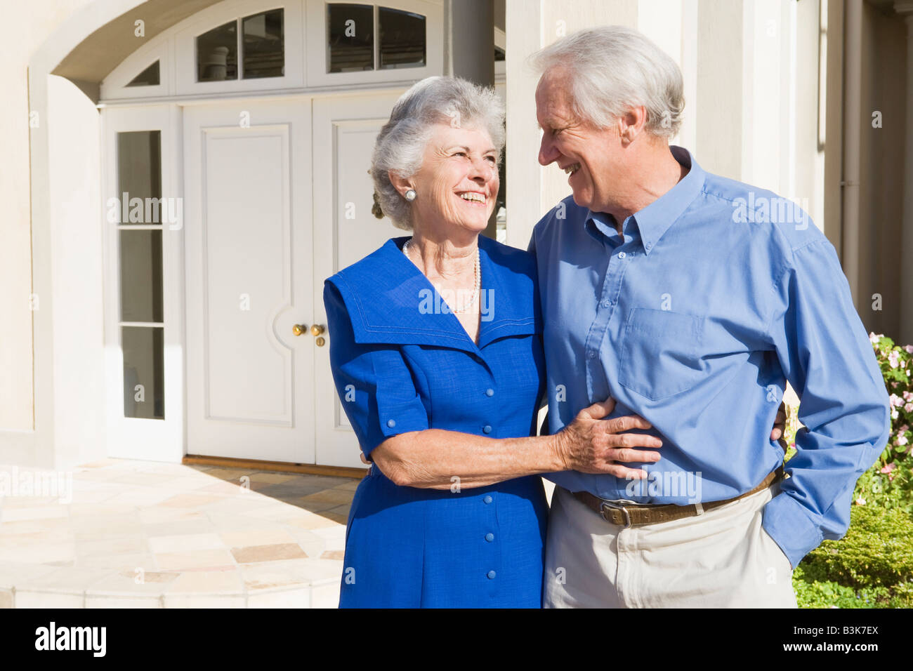 Senior couple standing outside their home Stock Photo - Alamy
