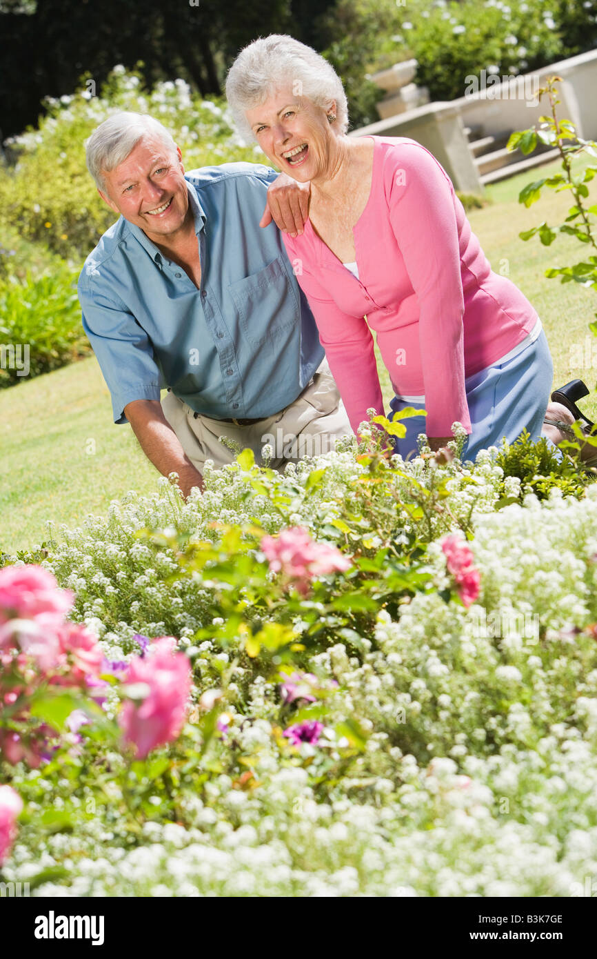 Senior couple in a flower garden Stock Photo