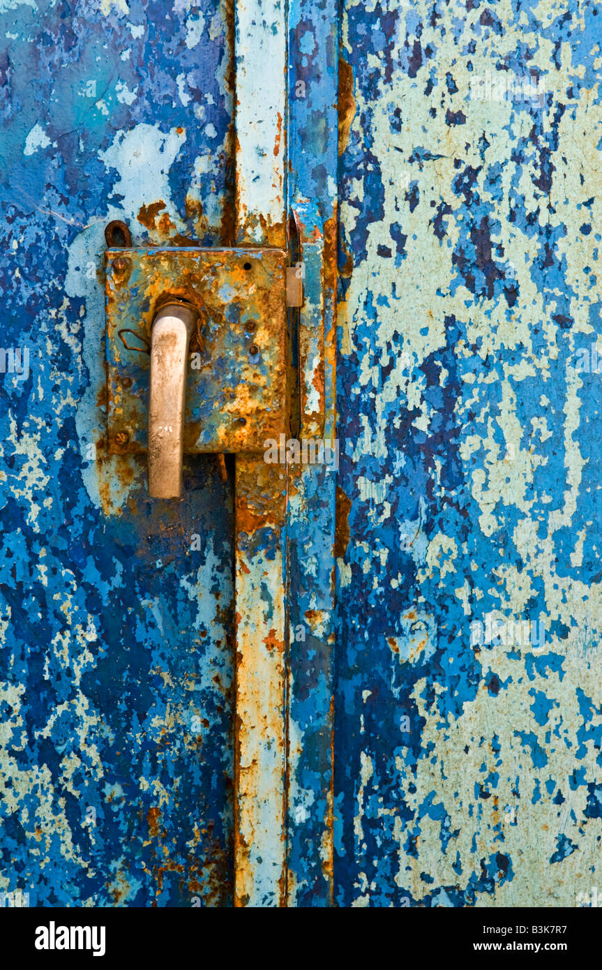 old metal door with peeling blue paint and rusty lock and handle Stock ...