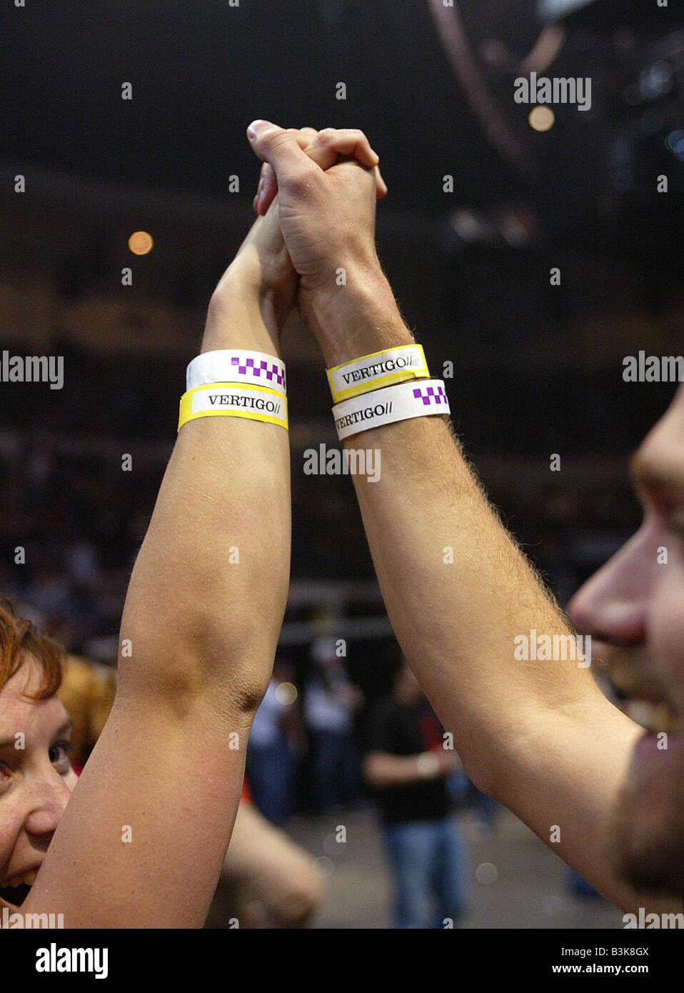 U2 fans with inside the oval wristbands in 2005 Stock Photo