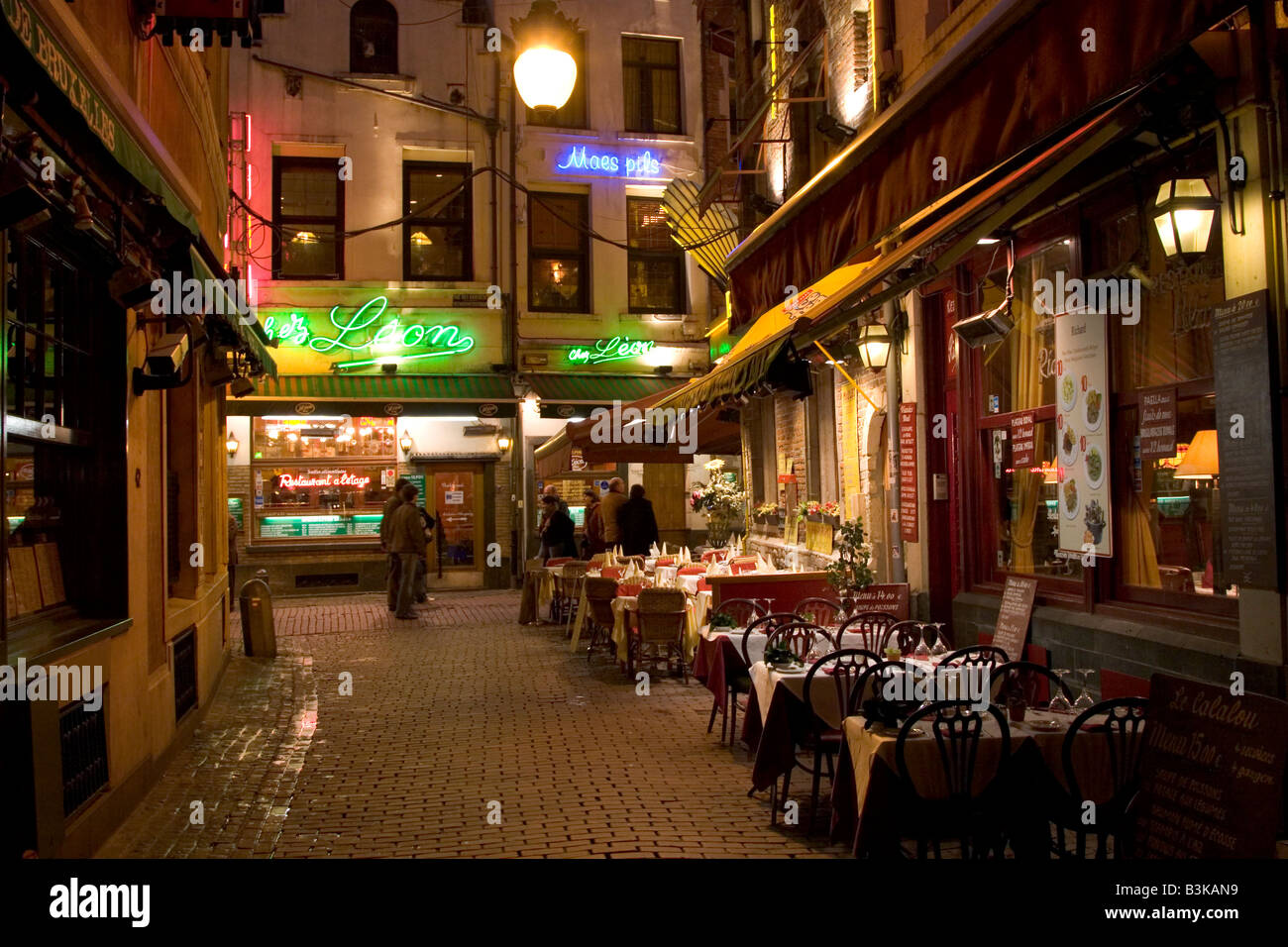 Neon lit exteriors of Restaurants along the Rue des Bouchers in Brussels Belgium Stock Photo