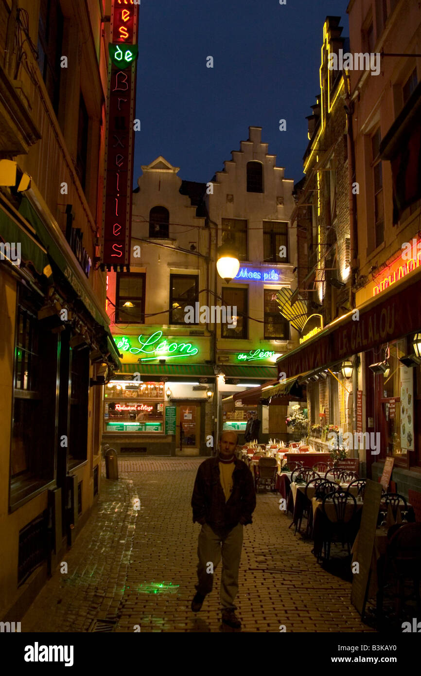Neon lit exteriors of Restaurants along the Rue des Bouchers in Brussels Belgium Stock Photo