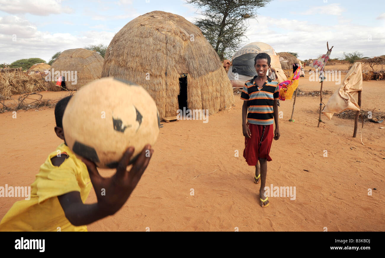 Idle Abdi Lahi 12 holding ball and Mohammed Nor Abdi at Belet Amin IDP (Internally Displaced People) camp, Somalia. Stock Photo