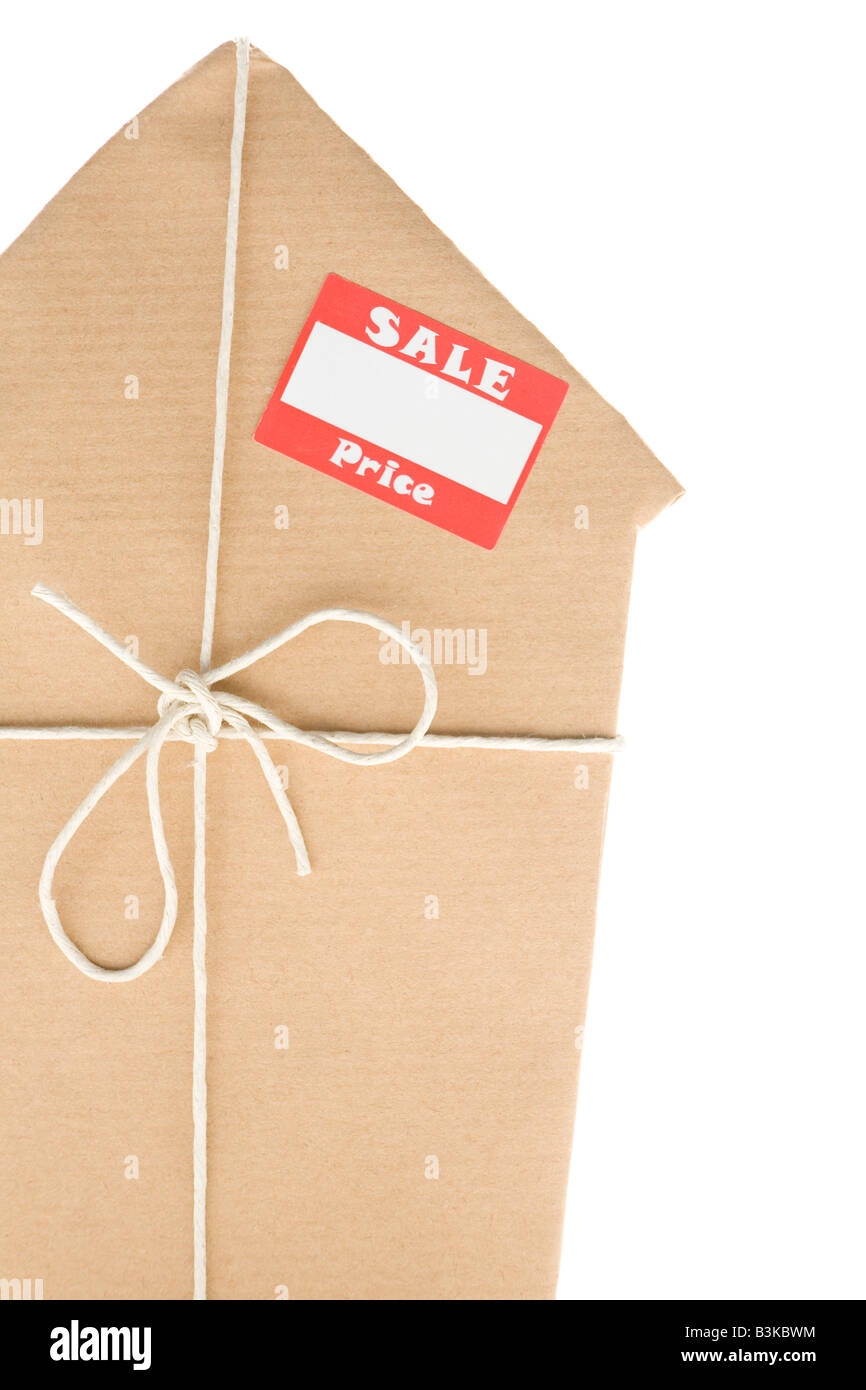 Studio Shot Of House Wrapped In Brown Paper With Sale Sticker Stock Photo