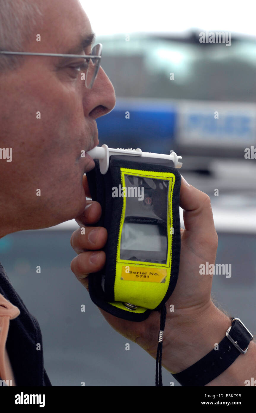 Close up of a police breathalyser being used on a man (posed by a model) Stock Photo