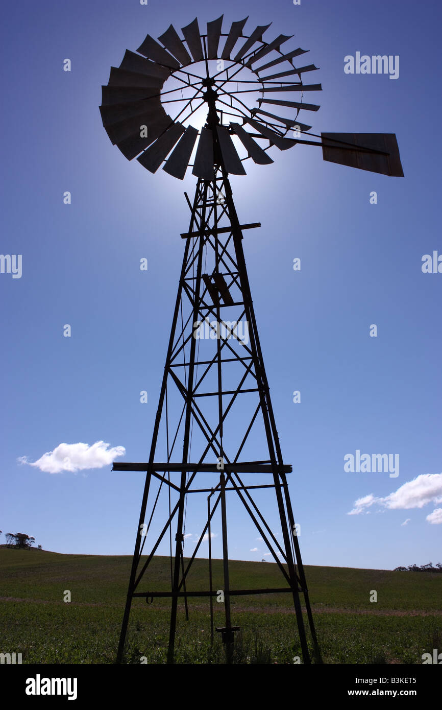 a windmill drawing water from a bore, in australia at midday Stock Photo