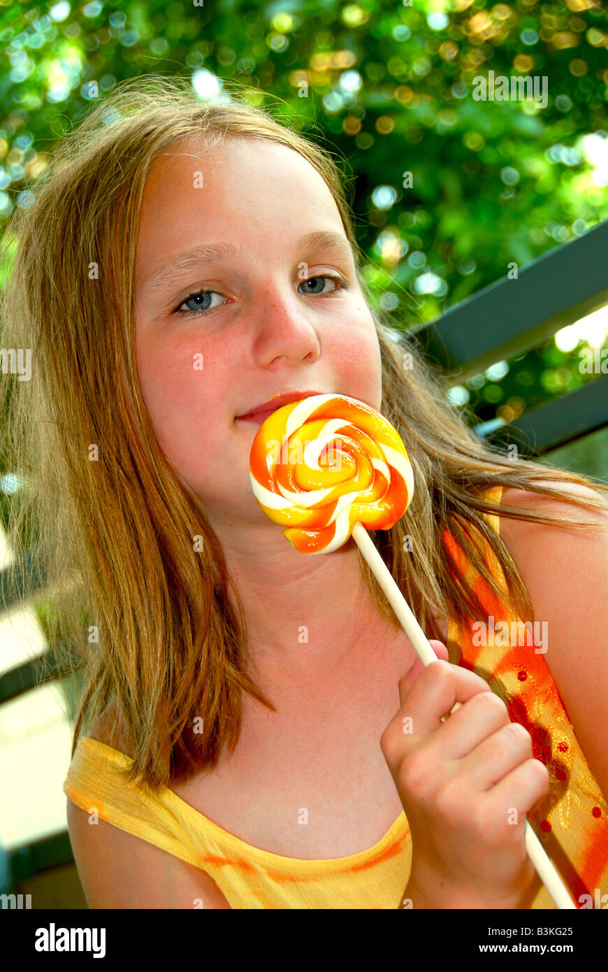 Young girl holding a big colorful lollipop candy Stock Photo