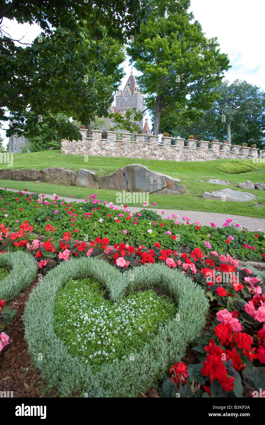 Heart Island and Boldt Castle: A heart shaped flower bed and the grounds of Heart Island  and the tower of the house Stock Photo