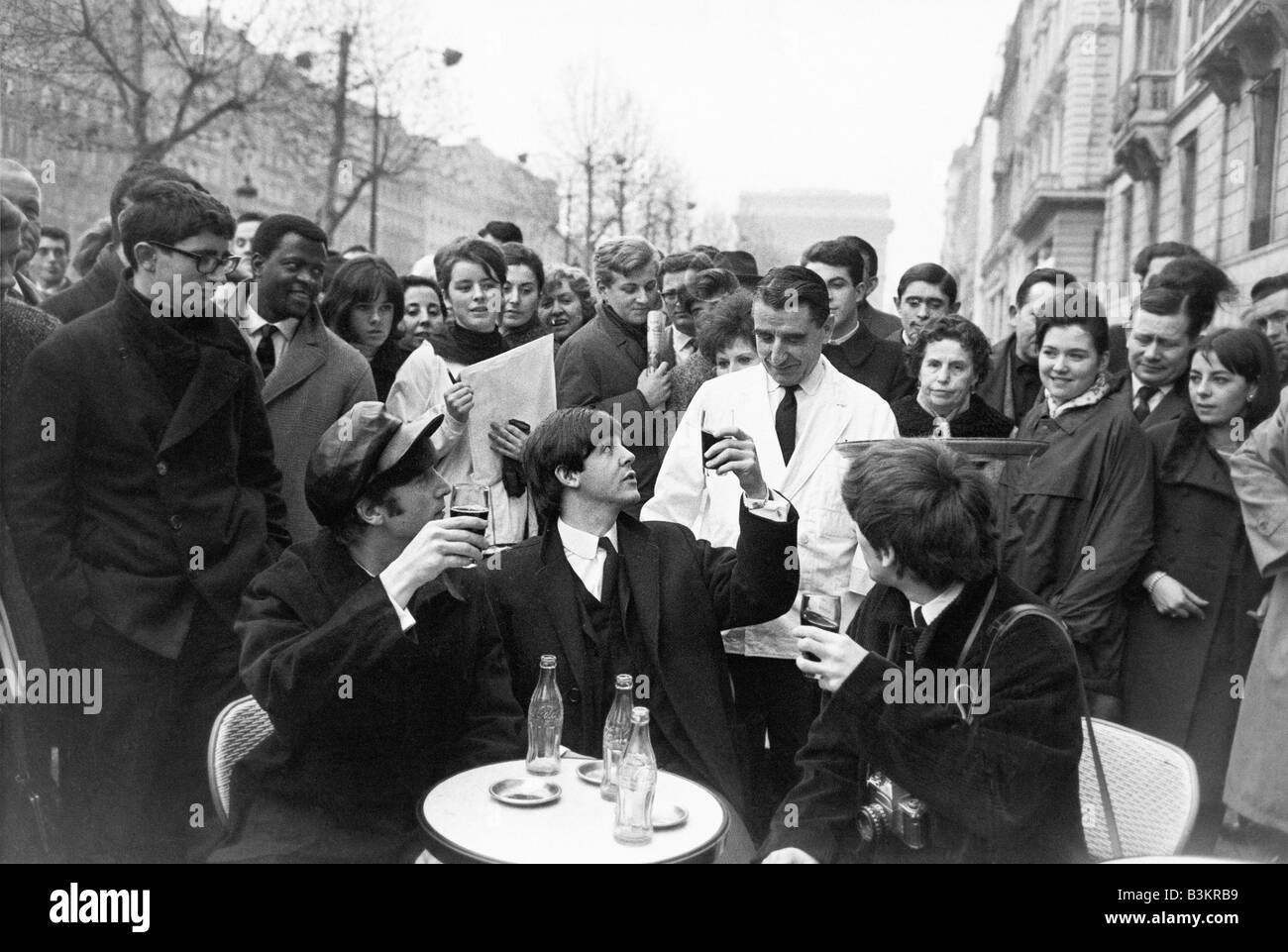 BEATLES at a cafe on the Champs Elysee in Paris January 1964 Stock Photo