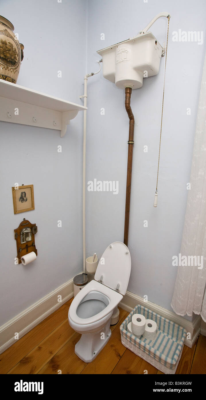 Pressure System. A high pressure plumbing system for a Danish toilet. The reservoir is mounted high in a high ceilinged room. Stock Photo