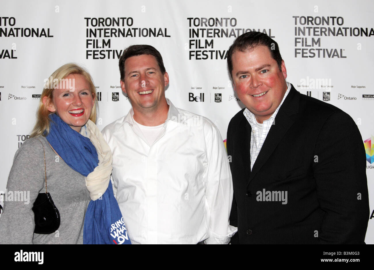 Participants of Toronto International Film Festival posing in front of the poster board at Dundas Square Stock Photo