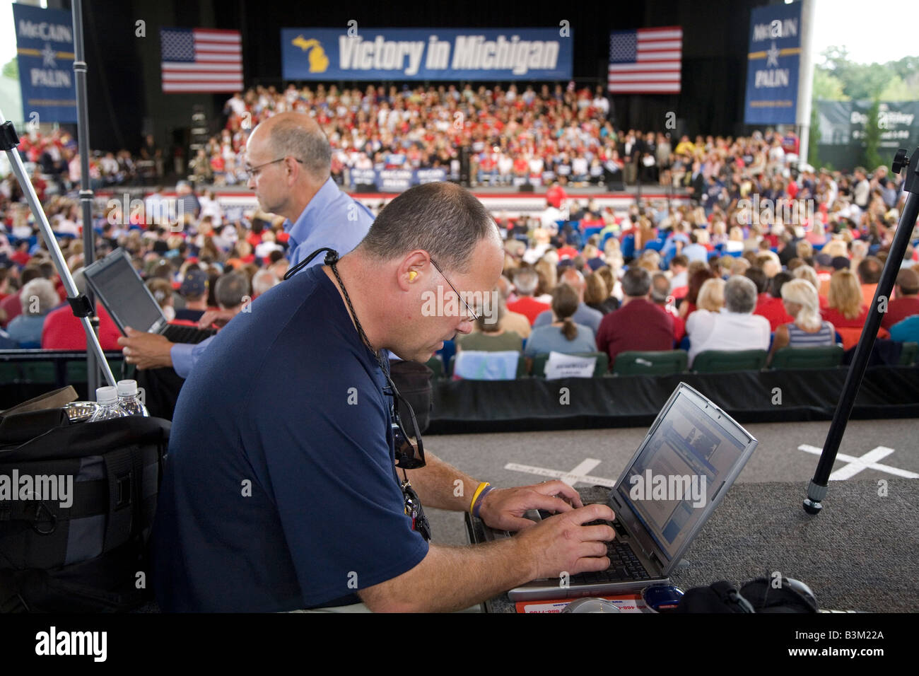 Photographers Edit Pictures on Laptop Computers During Political Campaign Rally Stock Photo