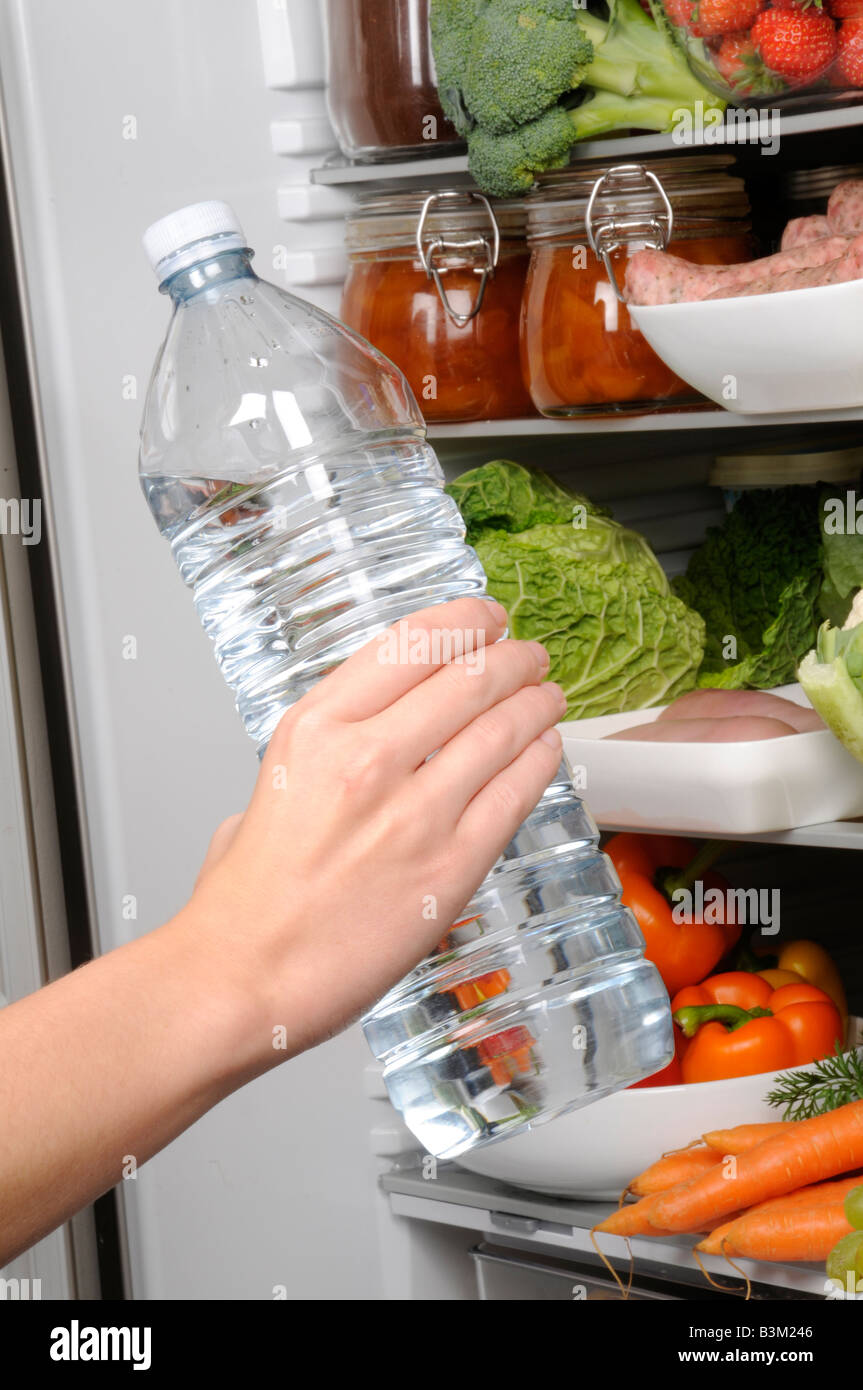 https://c8.alamy.com/comp/B3M246/man-taking-bottle-of-mineral-water-from-refrigerator-B3M246.jpg