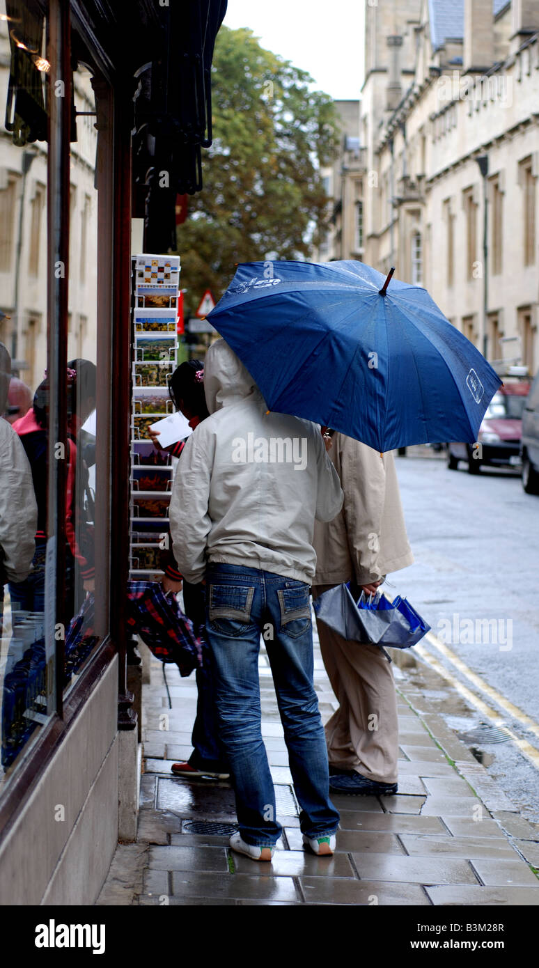 Tourist with umbrella in Turl Street, Oxford, Oxfordshire, England, UK Stock Photo