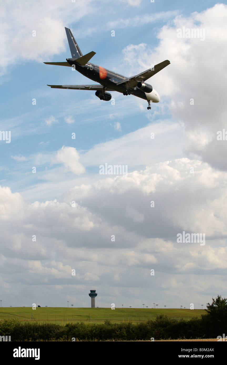 Titan Airways Boeing 757-256 Aircraft approaching Stansted Airport with ATC in background Stock Photo