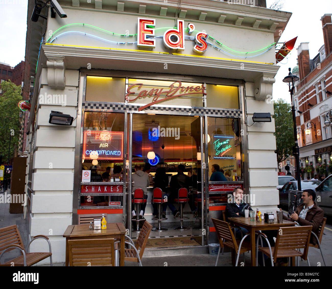 People Sitting Outside Eds Diner Soho West End London UK Europe Stock