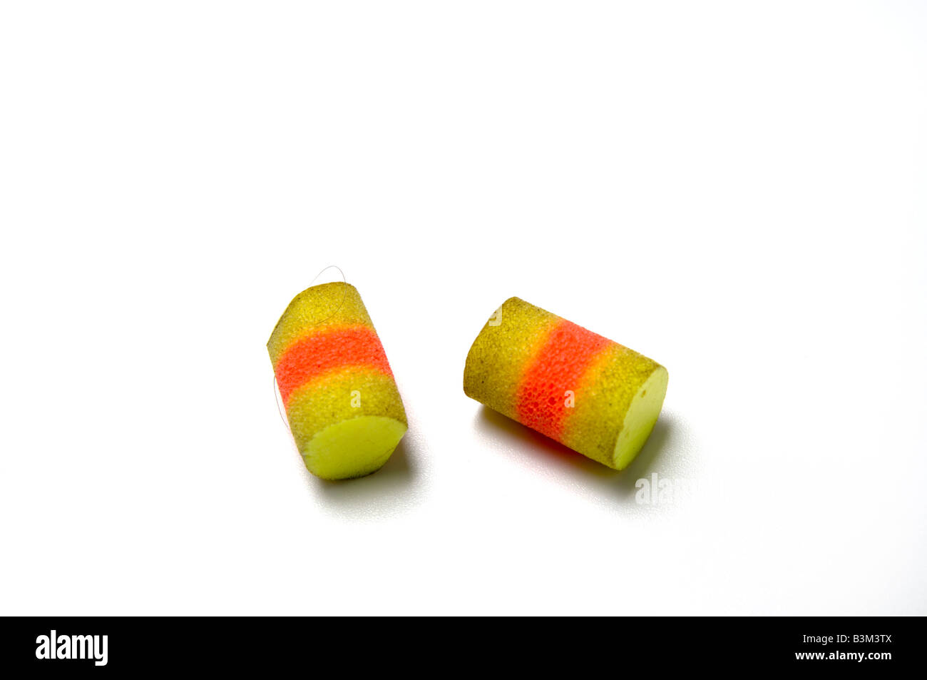 A pair of used yellow earplugs used to reduce noise including noise caused by snoring Stock Photo