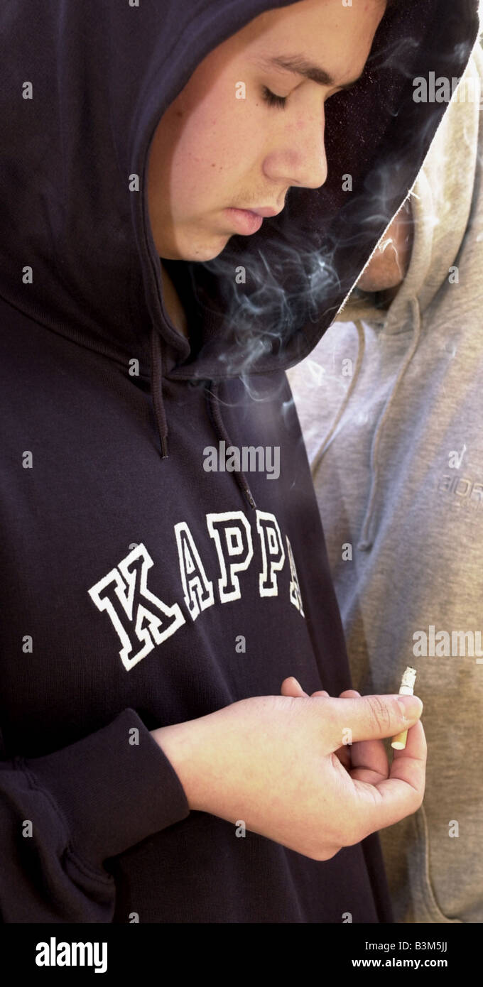 Hoodies hoodys teenagers children gangs MODEL RELEASED cigarettes cigarette smoking Stock Photo