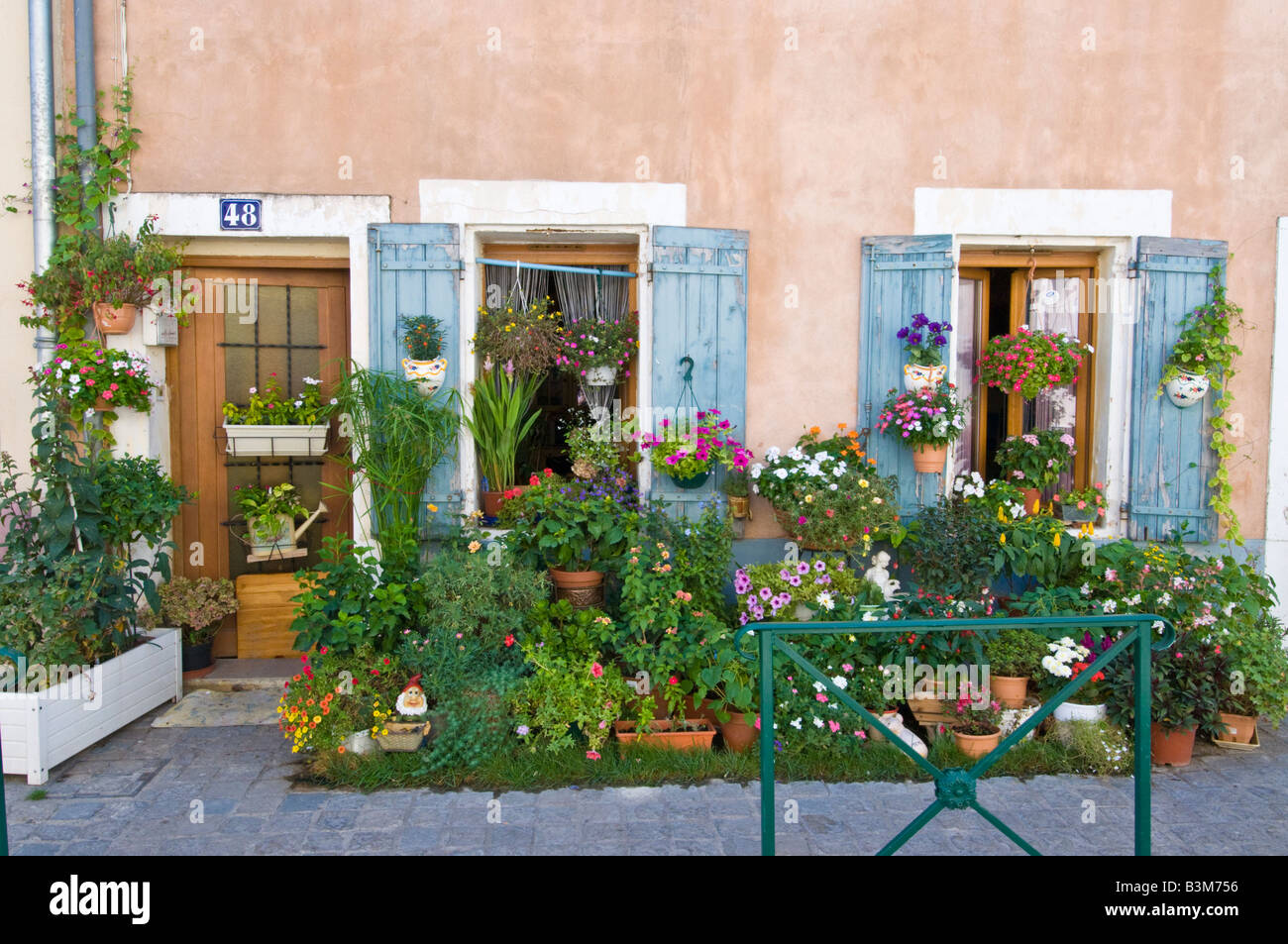 A small patio garden on the pavement outside a terraced house in Aigues Mortes, France. Stock Photo