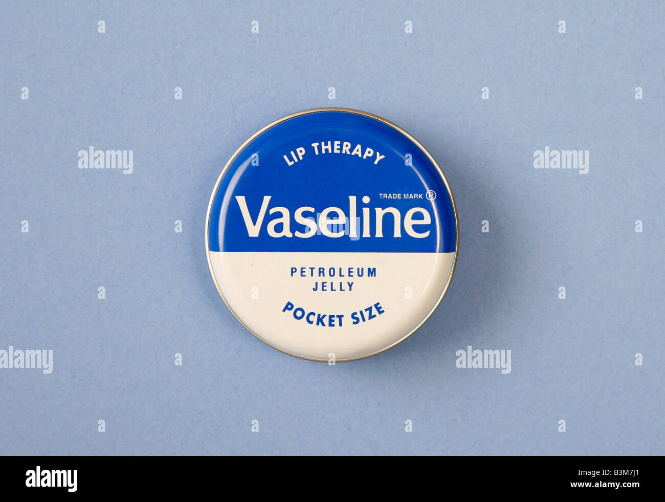Studio shot of a pocket-sized tin of Vaseline, petroleum jelly - Stock Image