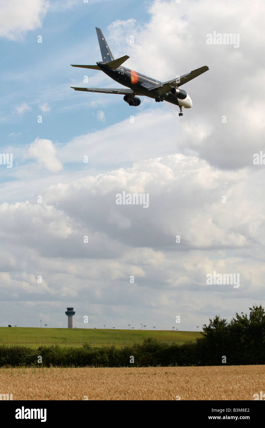 Titan Airways Boeing 757-256 Aircraft approaching Stansted Airport with ATC in background Stock Photo