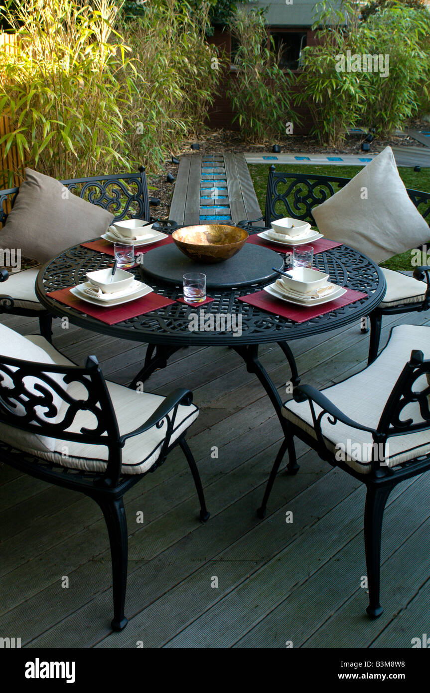 outdoor dining set in modern landscaped garden Stock Photo