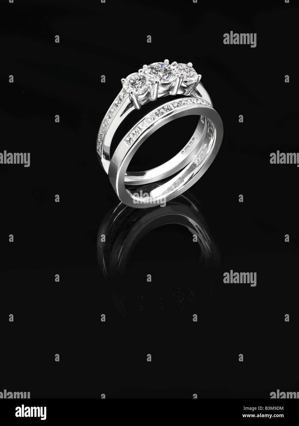 Platinum and diamond matching engagement and eternity ring Stock Photo