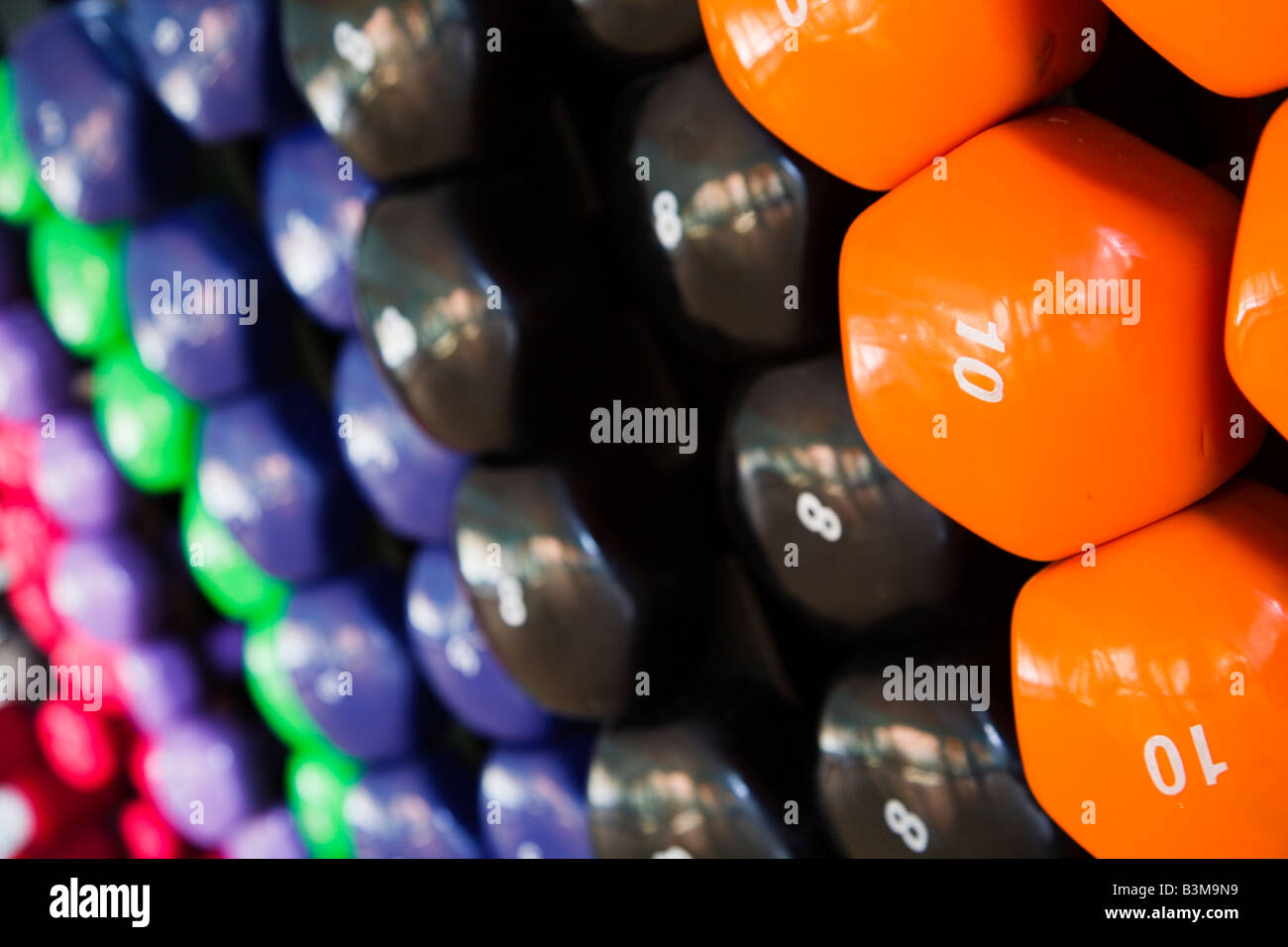 Closeup of multicolored dumbbells in a gym Stock Photo