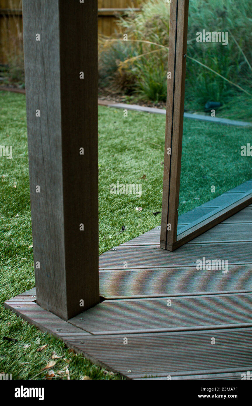 tinted perspex and wood gazebo in landscaped garden with decking and astro turf Stock Photo