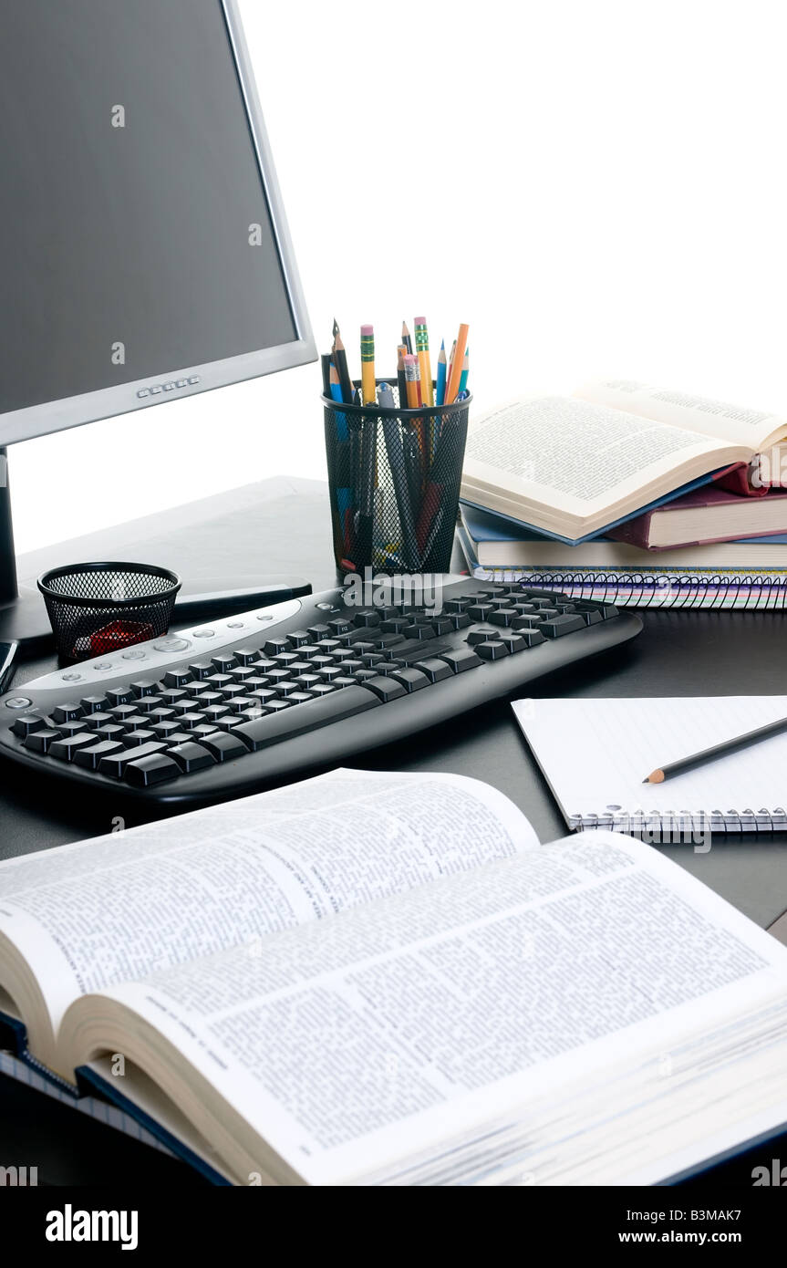 Piles of books open with a computer Working on a research paper Stock ...