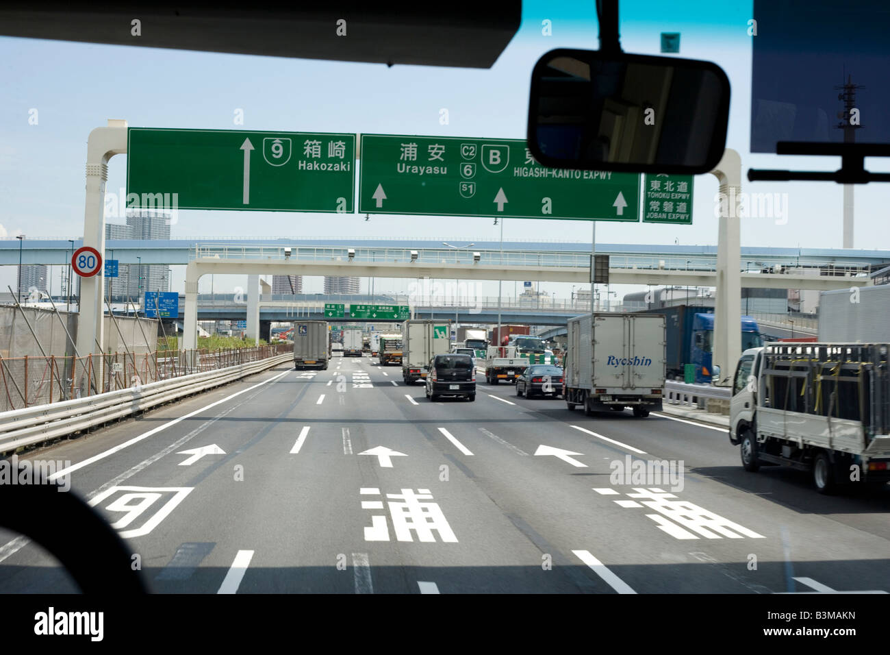View of Tokyo highway, driving to Narita Airport, Japan, with signs indicating which lane to take Stock Photo