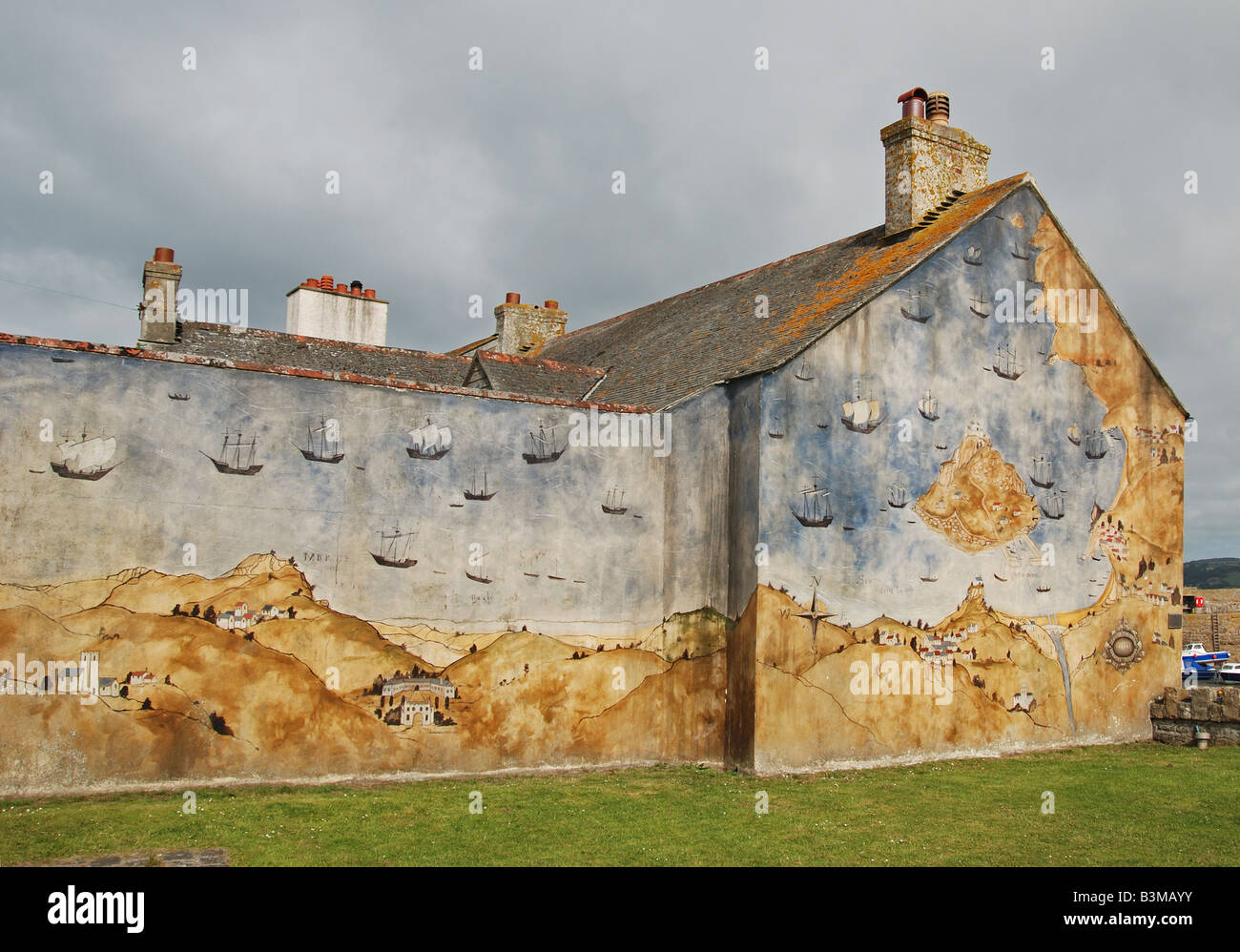 a mural of the story of "st.michaels mount" on the side of a building on st.michaels mount island,cornwall,uk Stock Photo