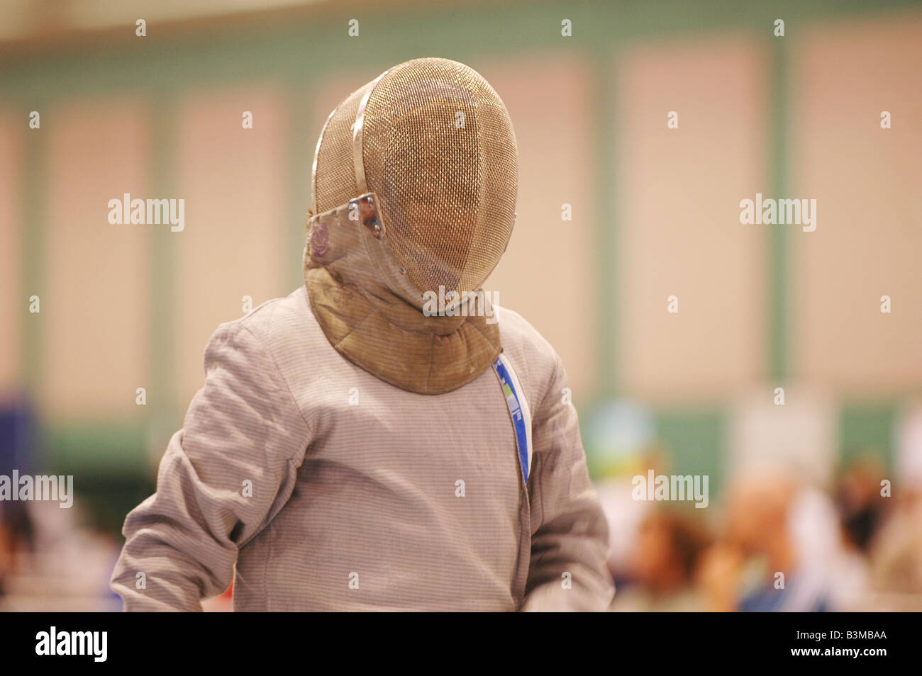 young man in fencing mask and lame ready for competition in fencing