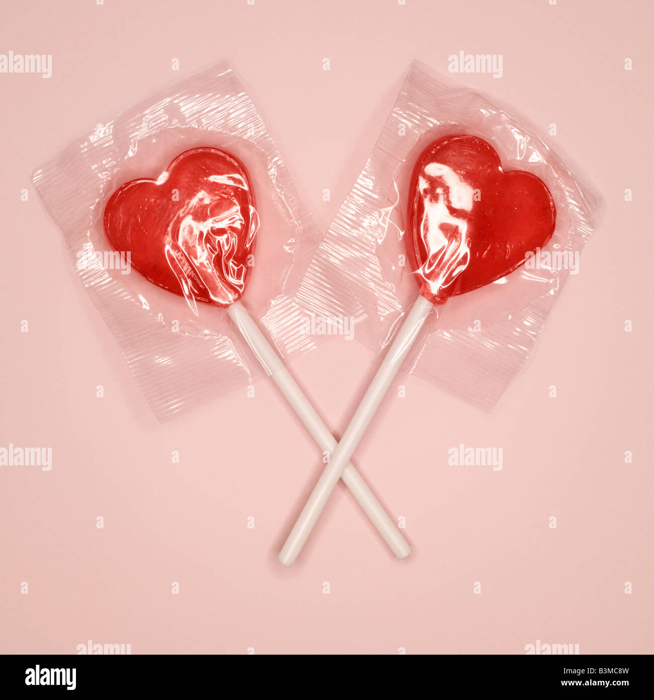 Red heart-shaped lollipops, elevated view Stock Photo - Alamy