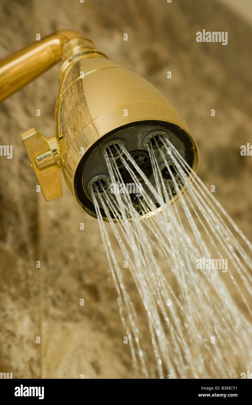 water flowing from golden colored shower head Stock Photo Alamy