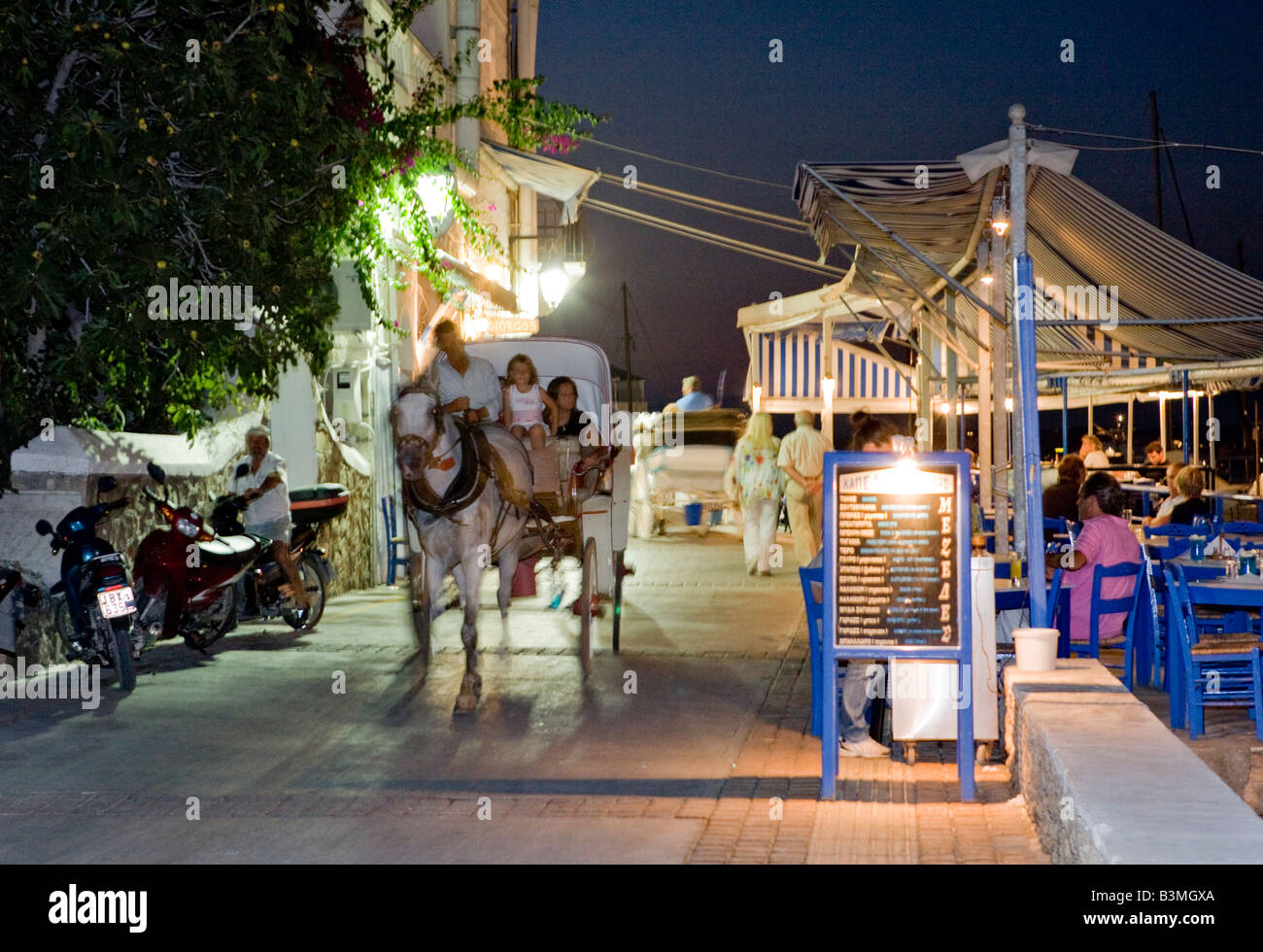 Horse And Carriage Nightime Old Harbour, Spetses, Greece Hellas Stock Photo