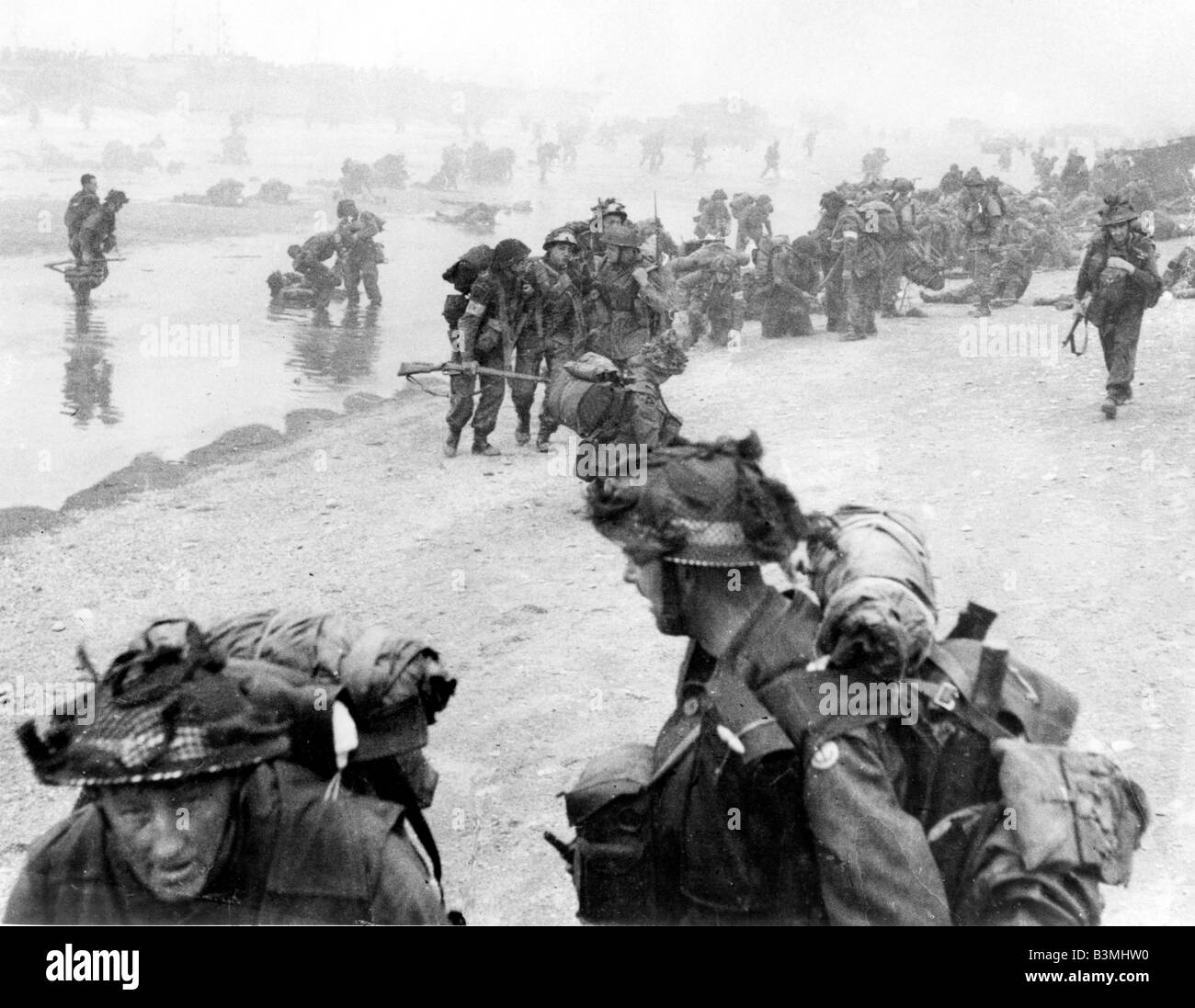 D-DAY 6 June 1944. British soldiers  struggle ashore on SWORD  beach in Normandy- see Description below for details Stock Photo