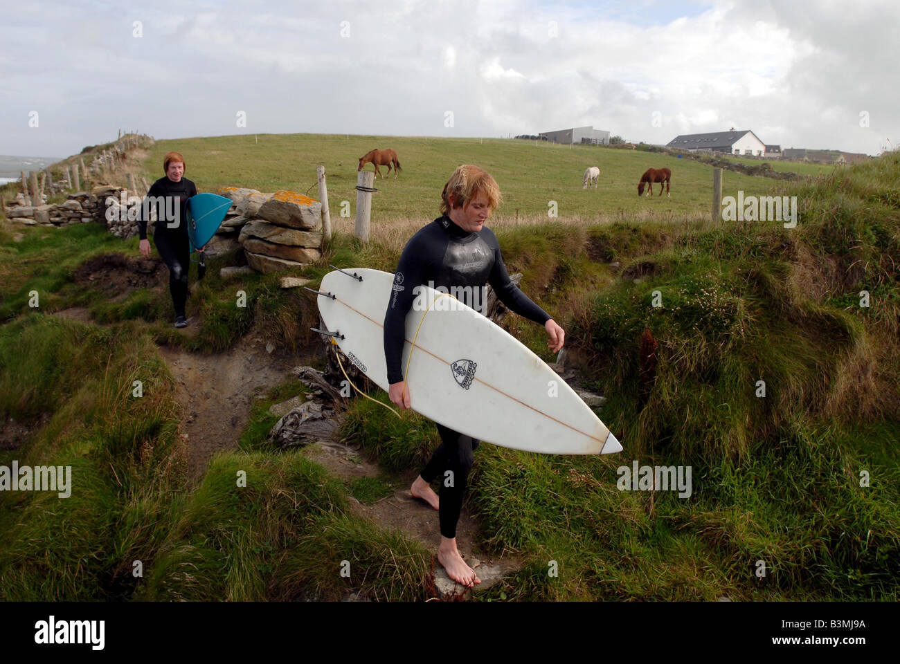 Surfers near Lahinch strand, surfing has become a very popular sport in Ireland Stock Photo