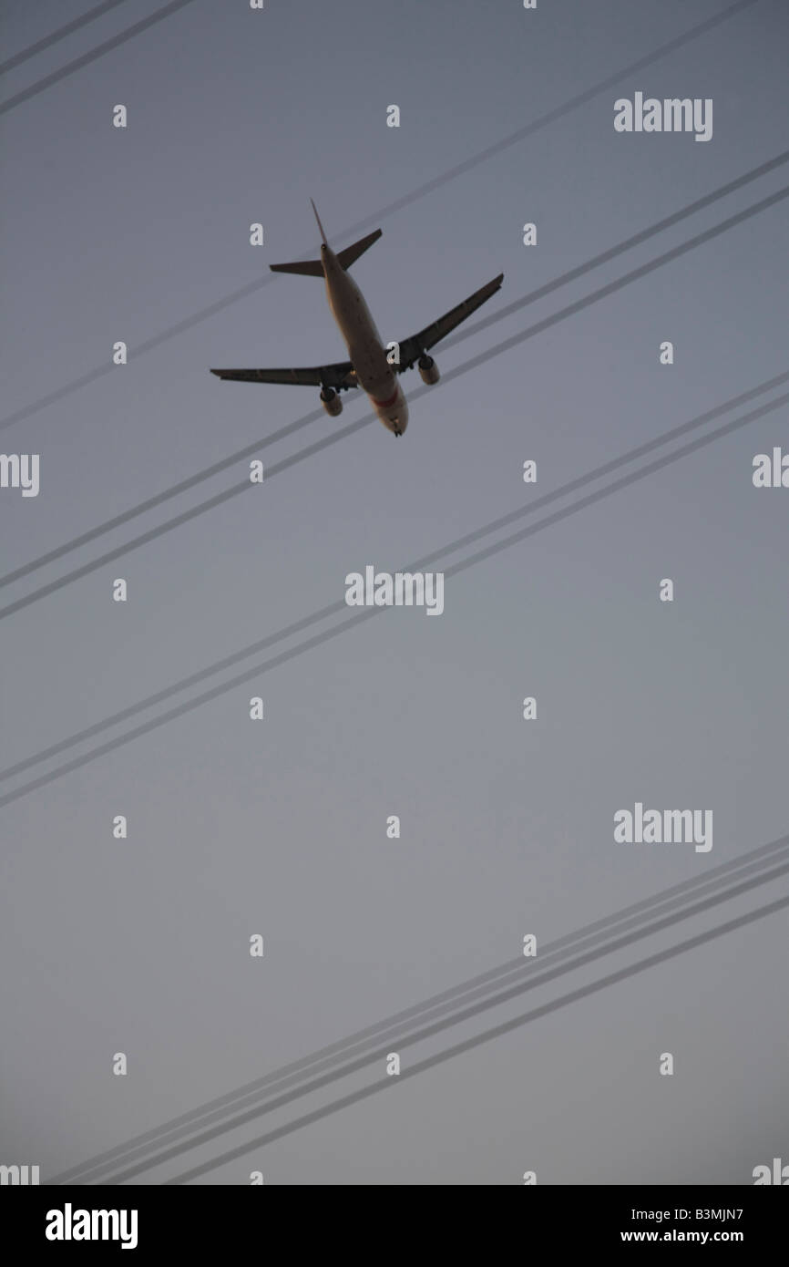 Plane and Transmission power electricity lines cables qatar Stock Photo