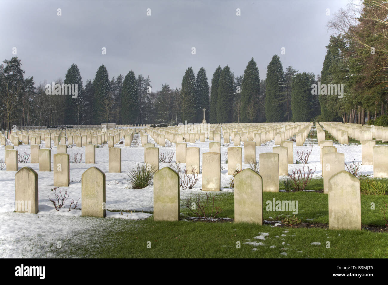 Canadian Military Cemetery Cross of Sacrifice and Grave Markers in Snow Stock Photo