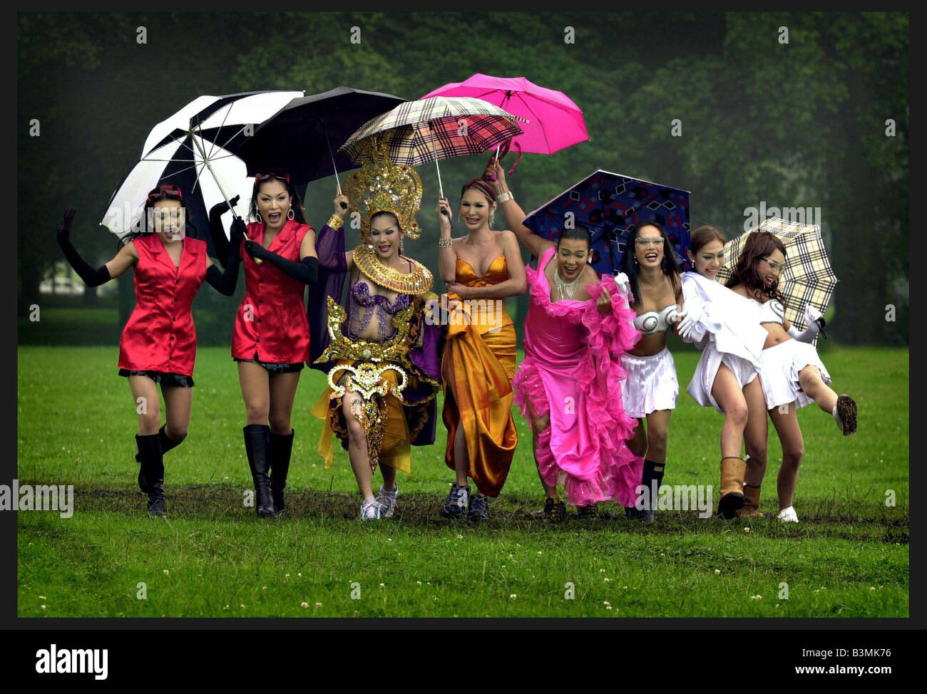 The famous Thai Ladyboys of Bangkok in Edinburgh for the Festival July 2002 The Ladyboys dancing in the rain and mud mirrorpix Stock Photo