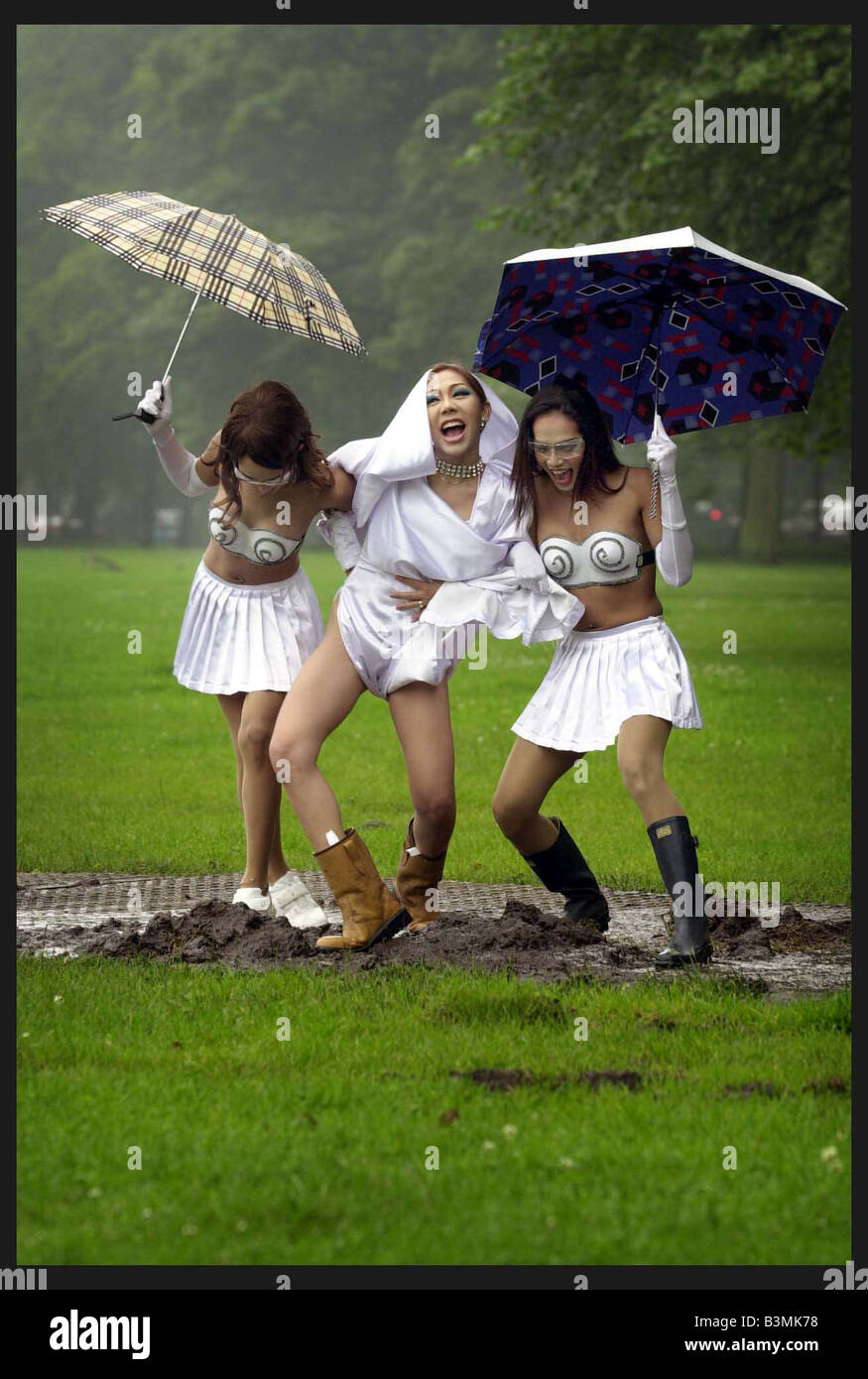 The famous Thai Ladyboys of Bangkok in Edinburgh for the Festival July 2002 Kylie middle Look a like with chums in the mud Stock Photo